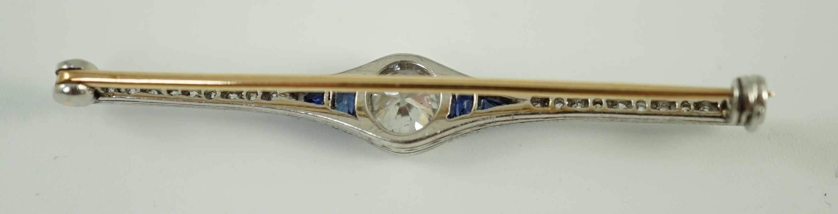 A 1920's platinum and gold, diamond and synthetic? sapphire set bar brooch